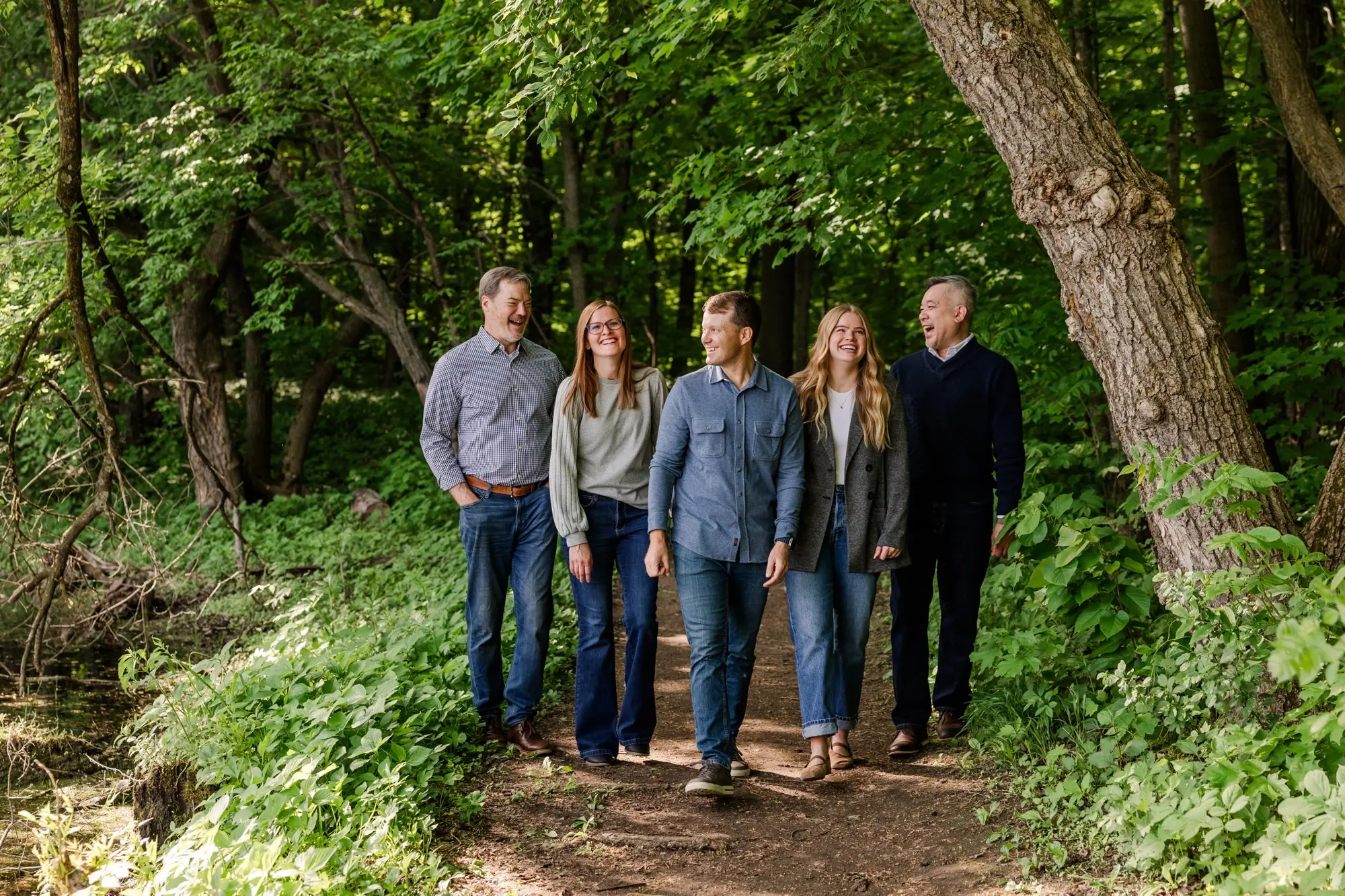 The 49 North Advisors team of five walking together along a wooded trail